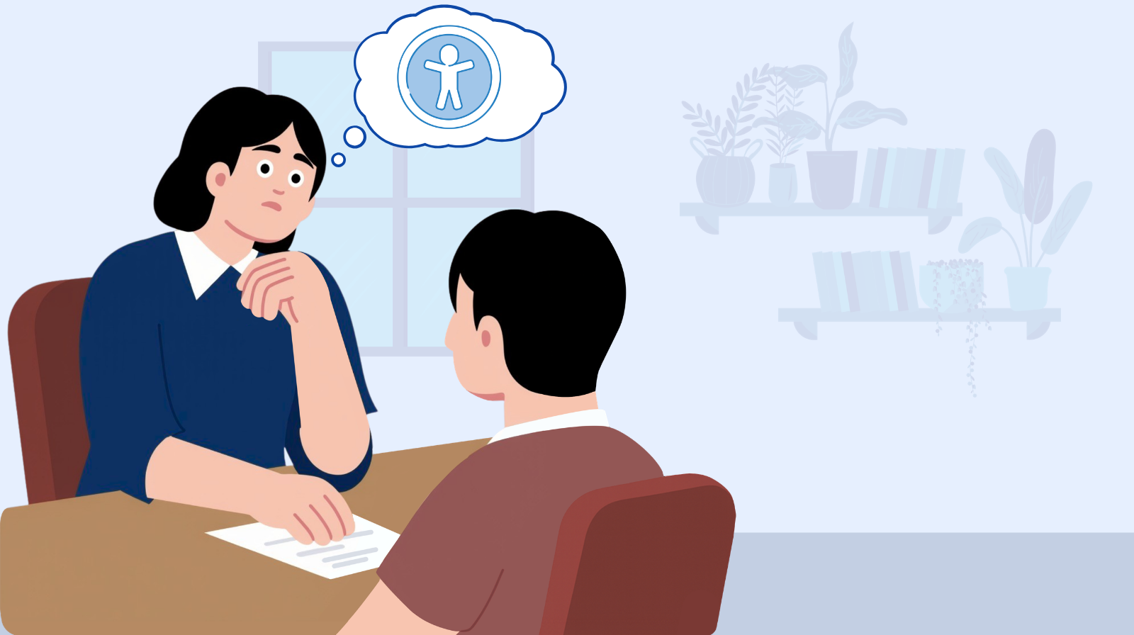 A web designer sitting at her desk thinking about web accessibility while talking to a client in an office setting.